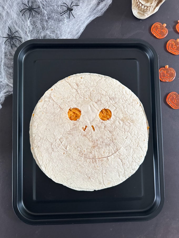 Two tortilla wrap being put together to create the quesadilla. 