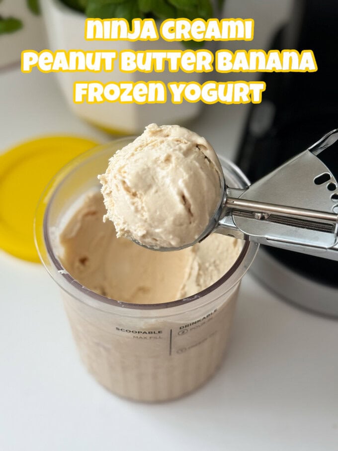 A Ninja Creami tub containing peanut butter banana frozen yogurt with a scoop being taken with a stainless steel ice cream scoop.